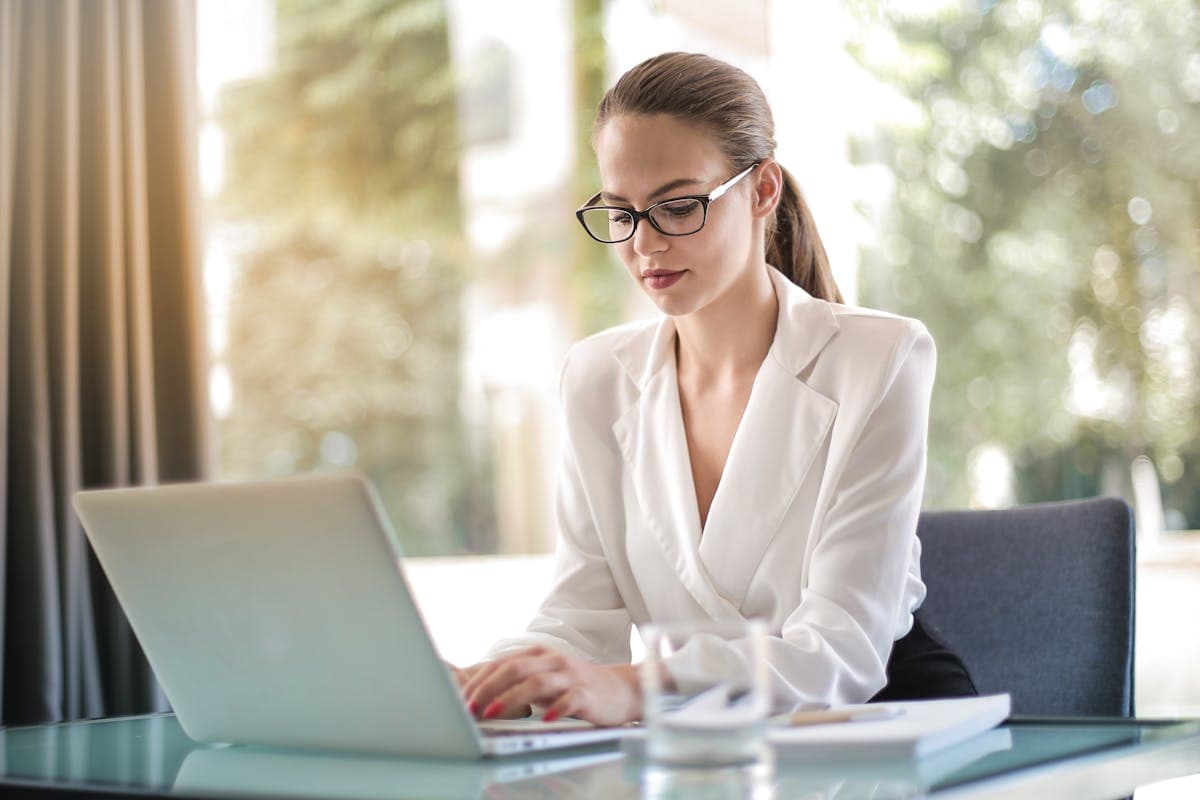 Focused businesswoman working on laptop at her desk
